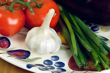 Image showing Tomatoes, garlic and scallions on a plate.