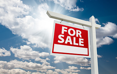 Image showing For Sale Real Estate Sign over Clouds and Blue Sky