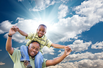 Image showing Happy African American Man with Child Over Clouds and Sky