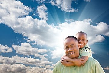 Image showing Happy African American Man with Child Over Clouds and Sky