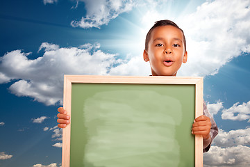 Image showing Proud Hispanic Boy Holding Blank Chalkboard Over Sky