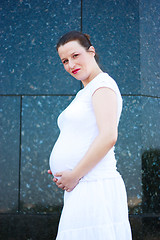 Image showing Beautiful young pregnant girl holding her belly