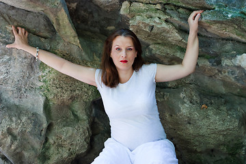 Image showing Beautiful young pregnant girl with stones in the background