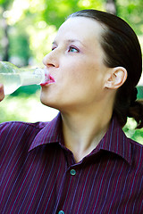 Image showing Beautiful young woman drinking