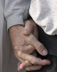 Image showing older couple holding hands