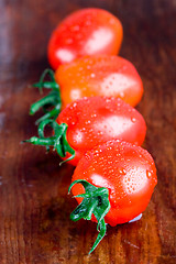 Image showing four wet tomatoes