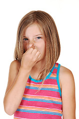 Image showing Girl holds her nose closed.