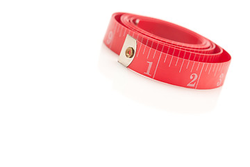Image showing Coiled Red Measuring Tape on White