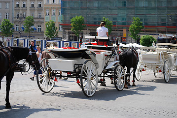 Image showing Horse-drawn buggies trot around Krakow 