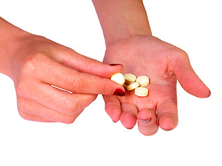 Image showing Nurse's hands offering the pills-over white background