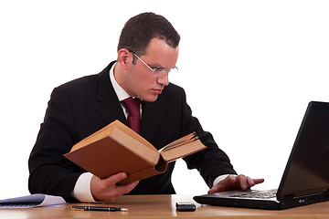 Image showing man on desk reading and studying