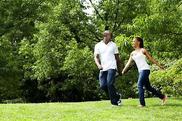 Image showing Happy couple running in park