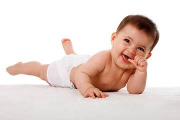 Image showing Happy baby laying on floor