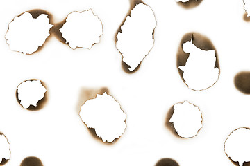 Image showing differently burnt shapes on white paper