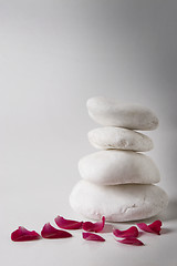 Image showing red petals and white pebbles, meditation concept