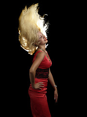 Image showing Hot blonde in red dress shaking hair