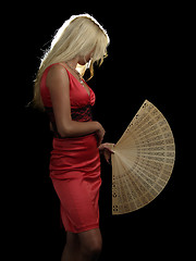 Image showing Hot blonde in red dress with fan