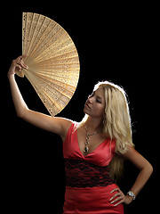 Image showing Hot blonde in red dress with fan