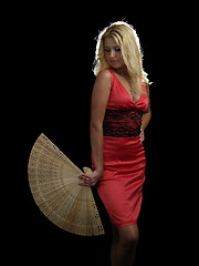 Image showing Hot blonde in red dress with fan
