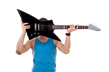 Image showing player holding his guitar over face
