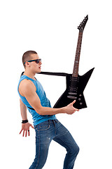 Image showing guitarist holding his guitar in one hand