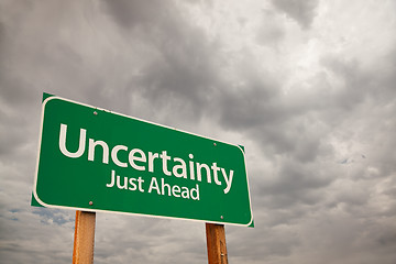 Image showing Uncertainty Green Road Sign Over Storm Clouds