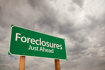 Image showing Foreclosures Green Road Sign Over Storm Clouds