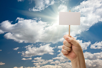 Image showing Man Holding Blank Sign Over Clouds and Sky