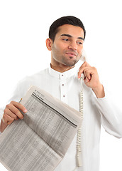 Image showing Stockbroker or Businessman on phone holding newspaper