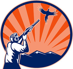 Image showing Hunter aiming shotgun rifle at bird pheasant