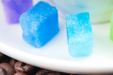 Image showing Multicolored slabs of shugar and cup of coffee 