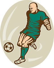 Image showing Soccer player kicking the ball