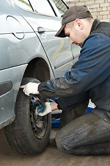 Image showing machanic repairman at tyre replacement