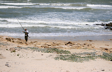 Image showing Fisherman on the rocks