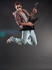 Image showing passionate guitarist jumps 