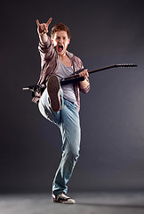 Image showing  kicking guitarist