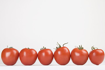 Image showing red tomatoes ready for salad, arranged in line