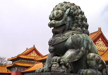 Image showing Beijing Forbidden City: lion statue against the roofs.