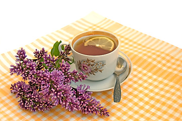 Image showing A cup of tea with lemon and lilac