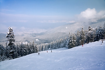 Image showing Ski slope and winter mountains panorama