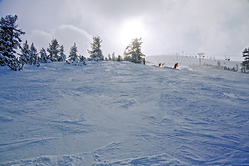 Image showing Skiers on the slope at winter resort