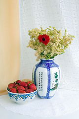 Image showing Strawberries and a vase with flowers