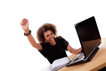 Image showing young black women in front of the computer, arm raised and happy