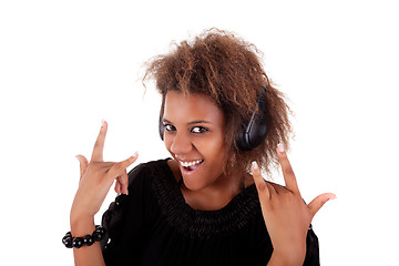 Image showing beautiful black woman listening music in headphones