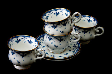 Image showing Four tea cups on saucer