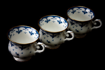 Image showing Three tea cups on saucer insulated on white background