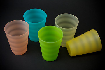 Image showing Colour plastic glasses on dark background