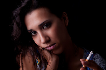 Image showing Young sexy brunette with cigarette