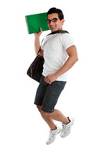 Image showing Jumping student holding book