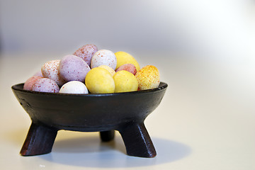 Image showing Mini candy chocolate eggs in a decorative tripod dish